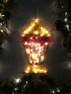 a lighted christmas lantern in the shape of a bell