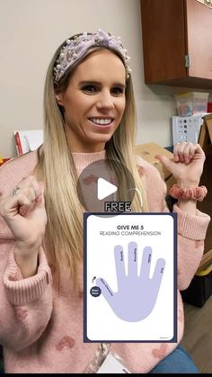 a woman holding up a fake hand print