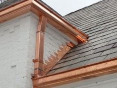 copper gutter on the roof of a house