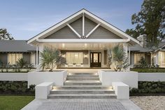 a house with steps leading up to the front door and entry way that leads into it