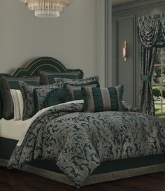 a bed with green and white comforters in a room