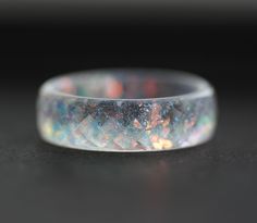 * ONE rainbow ring from my resin jewelry collection * resin band ring - about 6 mm/0.26 inches/width  * thickness - about 2.3 mm/about 0.09 inches/ * faceted ring  * clear ring with rainbow flakes and rainbow dust - this ring was inspired by the Sun You can see the other resin rings from the collection here: https://www.etsy.com/shop/ARTISUNtis?ref=seller-platform-mcnav&section_id=15714637 Features: * Hypoallergenic ring (suitable for the people with metal allergy) * For everyday and for special Diy Resin Ring, Iridescent Resin, Rainbow Ring, Resin Rings, Faceted Ring, Rainbow Rings, Resin Ring, Rings Simple, Stackable Rings