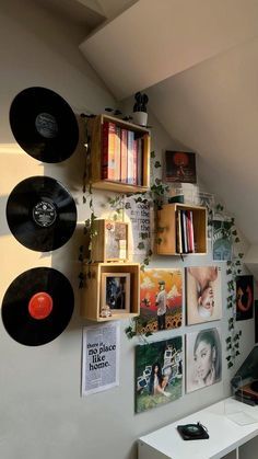 there are many records hanging on the wall next to each other in this home office