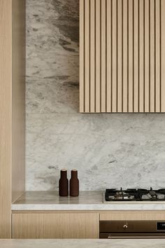 a stove top oven sitting inside of a kitchen next to a wooden cabinet and counter