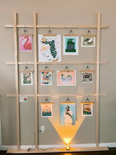 there is a shelf with pictures on it and a lamp in front of the shelves