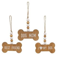 three wooden dog tags hanging from strings