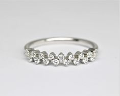 a white gold ring with five pear shaped diamonds