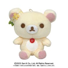 a white teddy bear with a flower on its head sitting in front of a white background