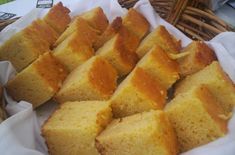 several pieces of bread sitting on top of a white paper towel next to a wicker basket