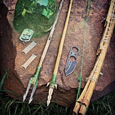 several different types of fishing equipment on a rock