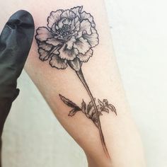 a black and white flower tattoo on the leg