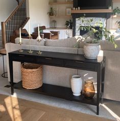 a living room filled with furniture next to a stair case