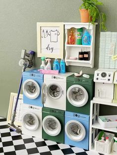 there are many washers and dryers in this toy laundry room with green walls