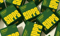 many green and yellow boxes with the words sipps on them, all stacked together