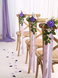 the chairs are decorated with purple flowers and ribbons