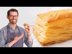 a man holding a piece of bread next to it