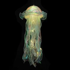 a jellyfish hanging from a ceiling in the dark