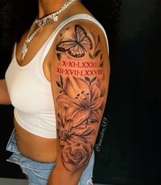 a woman with a butterfly and flowers tattoo on her arm