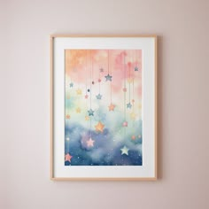 a painting hanging on the wall above a bed in a room with pink and blue walls