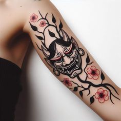 a woman's arm with a tattoo on it and flowers around the arm area