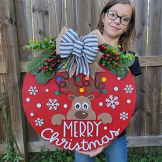 "The holiday season is in the air. This personalized Christmas door sign makes a perfect gift for weddings, housewarmings, anniversaries, etc! How it's made: This door sign is made of two layers. I cut the backing from 1/2\" birch plywood, the words and teams are cut from 1/4\" plywood.   Each piece is then hand painted, and glued together. Sign sizes are approximately 15\", 18\", 20\", and 22. Exterior lacquer is applied to the finished product to help extend the life of your door hanger. The b Christmas Wood Door Hangers, Reindeer Door Hanger, Christmas Front Door Decor, Christmas Tree Door, Reindeer Decor, Hanger Christmas, Door Hanger Christmas, Christmas Front Door, Front Door Christmas Decorations