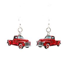 a pair of red truck earrings hanging from hooks