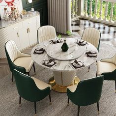 a round marble dining table surrounded by green and white chairs with gold trimmings