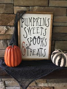 there is a sign that says pumpkins sweets and spooks treats on the mantle