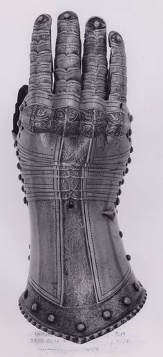 an old glove with metal rivets is shown in this black and white photo