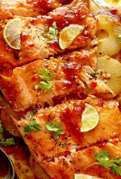 a close up of food on a plate with lemons and garnishes