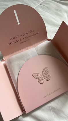 an open pink box with a butterfly on it