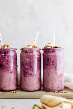 three jars filled with food sitting on top of a table