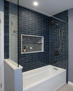 a white bath tub sitting next to a walk in shower