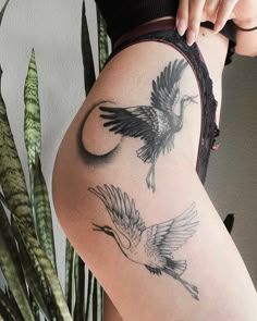 a woman's thigh with two birds on it