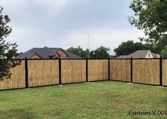 a fence that is in the middle of some grass