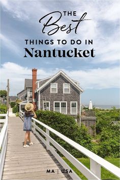 a woman in a hat is standing on a wooden walkway leading to a large house