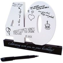 a white forty birthday candle holder with writing on it and a pen next to it