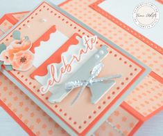 an orange and white card with flowers on it