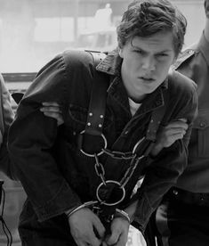 black and white photograph of a young man in handcuffs