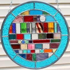 a circular stained glass window hanging from a chain