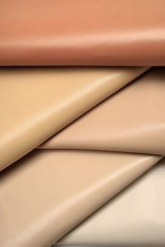 several different colored leathers stacked on top of each other