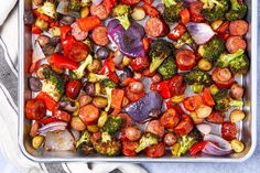 a pan filled with sausage, broccoli and red onions on top of a towel