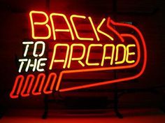 a neon sign with the words back to the arcade on it's front wall