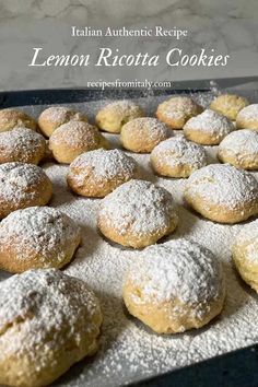 lemon ricotta cookies on a baking sheet with powdered sugar