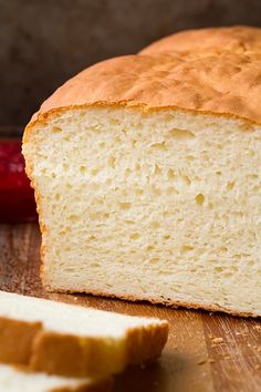 a loaf of bread sitting on top of a wooden cutting board