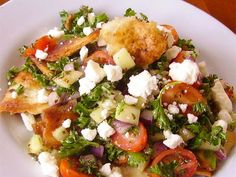 a white plate topped with salad and bread