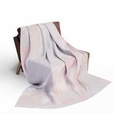 a chair with a blanket on it sitting in front of a white wall and floor