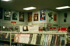 a record store filled with lots of records and cds on display in front of the camera