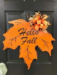 an orange and black fall door hanger with the words hello fall on it