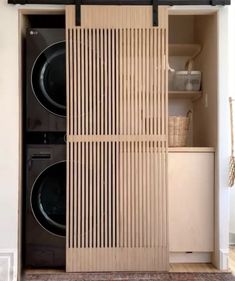 a washer and dryer in a room with wood paneling on the doors